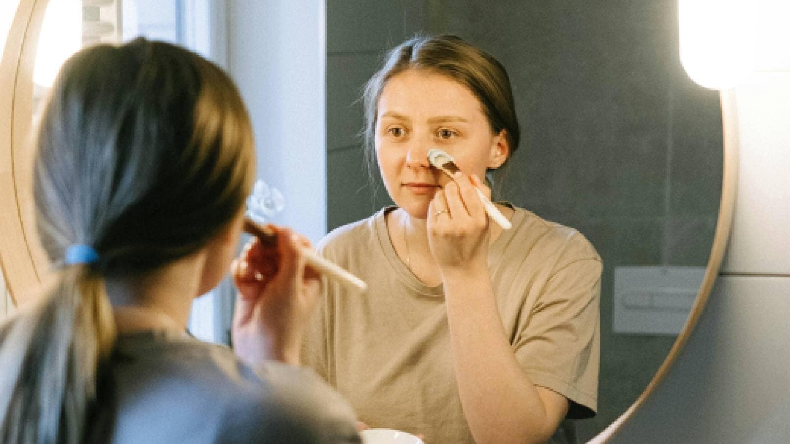 A woman applying a face mask