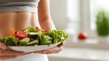A woman with a plate full of healthy food