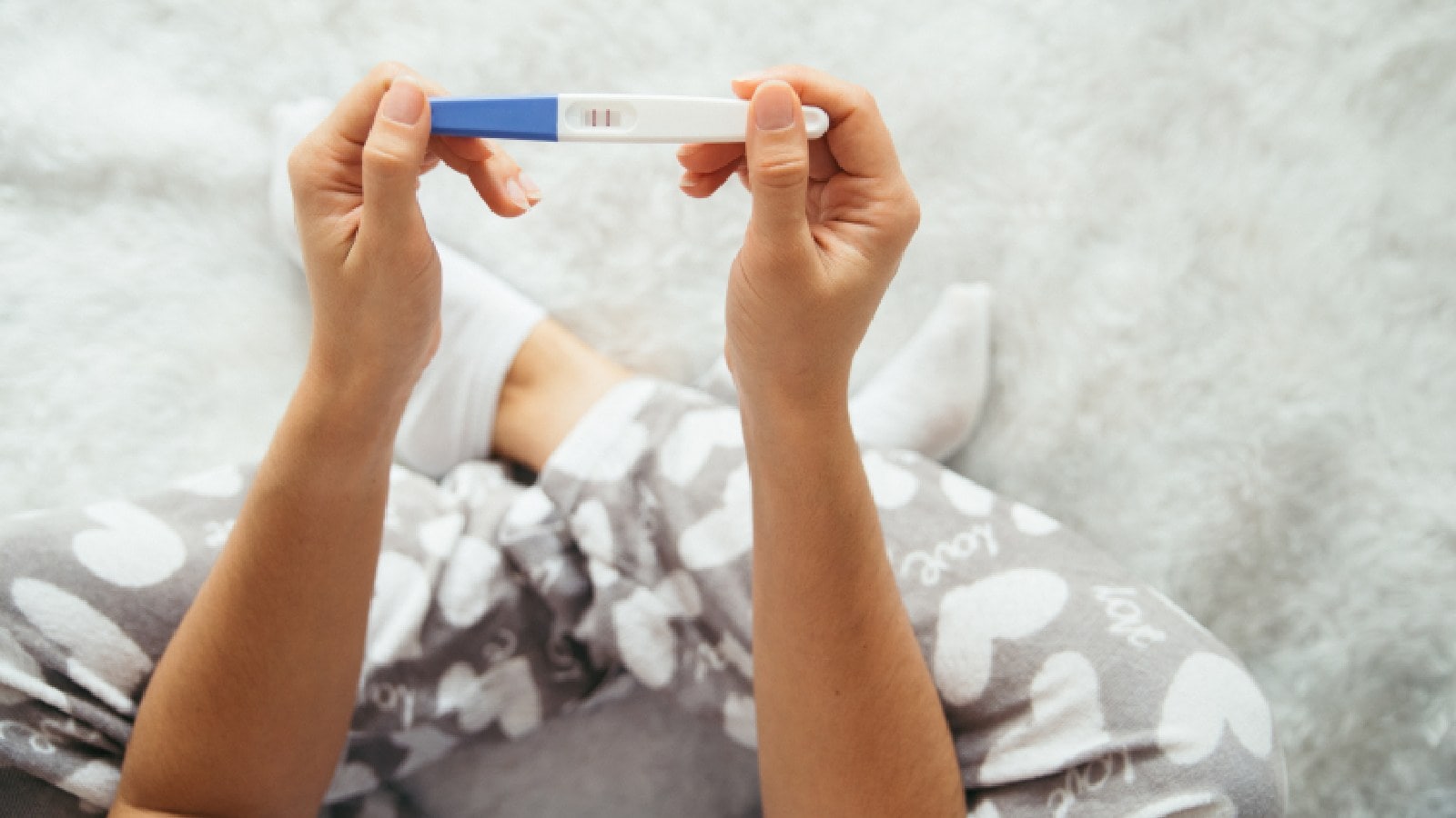 A woman checking pregnancy at home
