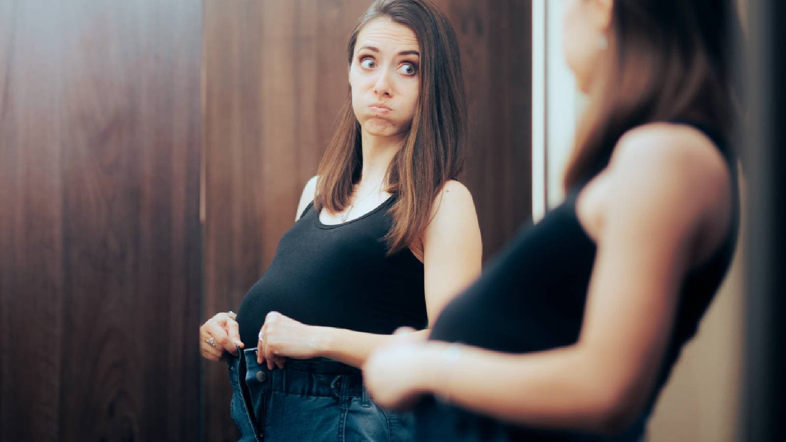 A woman looking at herself in the mirror