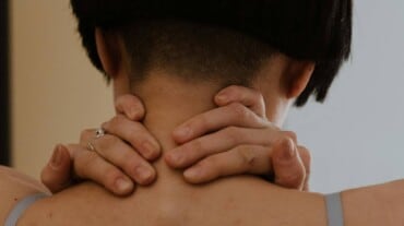 A woman massaging her neck.